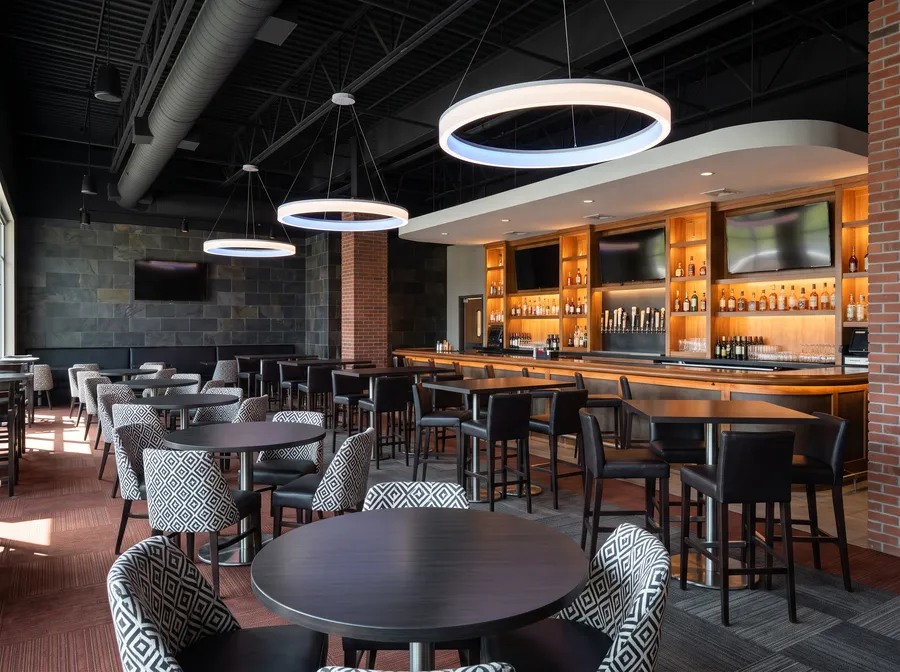 Lounge with blue ring lights and a long bar